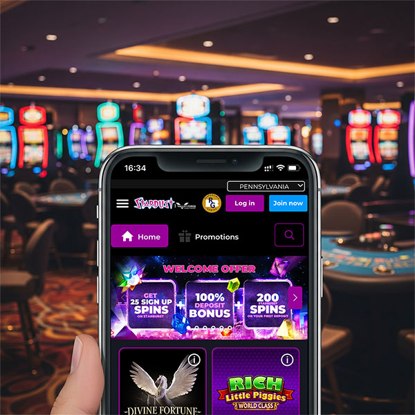 Mobile phone in a casino showing Stardust Online Casino Pennsylvania.